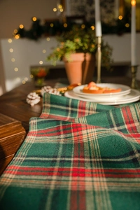 Close-up of green festive plaid table runner fabric with a soft flannel texture