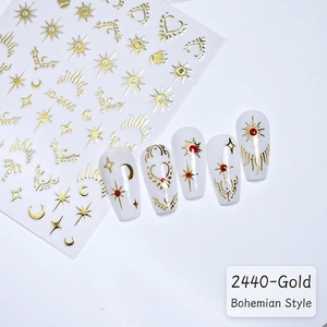 Detail of gold star and moon bohemian nail stickers with sun patterns and model nails