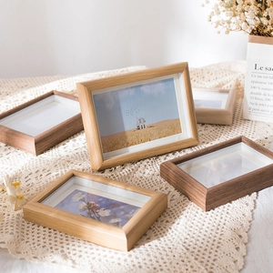 Minimalist deep-profile wooden picture frames in light oak and walnut finishes