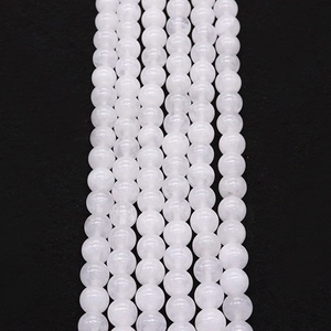 Detailed macro view of natural white jade stone round beads for DIY jewelry making