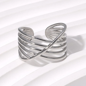 Macro shot of a multi-layer silver stainless steel open ring with crossed line design