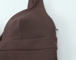 Detailed close-up of brown dress featuring hidden side zipper and tailored bodice seams