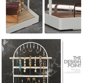 Detailed macro view of white metal jewelry stand with natural wood base and multi-layer hooks