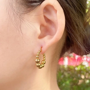 18k gold plated stainless steel hoop earrings with gradient metal beads on model