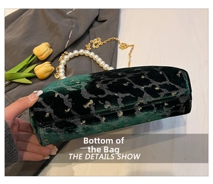 Detailed close-up showing the smooth flat bottom of the green velvet shell bag