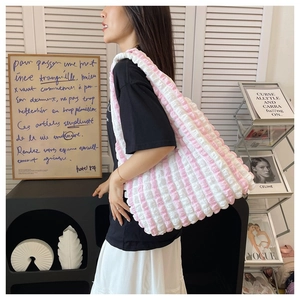 Detailed view of pink and white striped bubble texture on this large shoulder bag