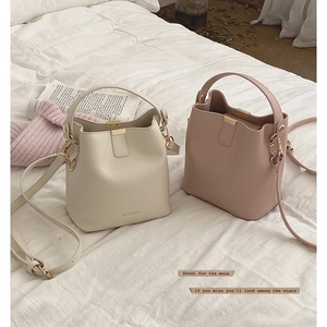 Fashionable PU leather bucket bags in off-white and pink with adjustable shoulder straps