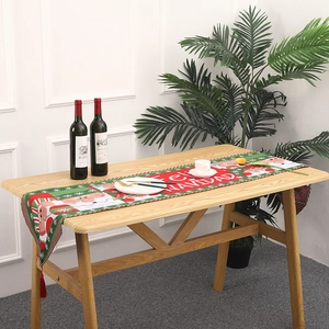 Close-up of knitted Christmas table runner with Santa Claus and Feliz Navidad text