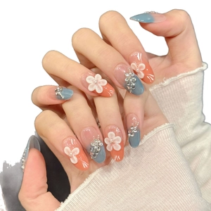 Handmade almond press-on nails with blue-orange gradient, 3D floral accents, and pearls