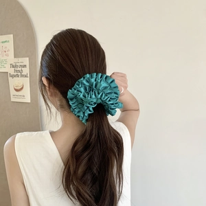 Teal pleated satin oversized hair scrunchie shown on low ponytail with French aesthetic