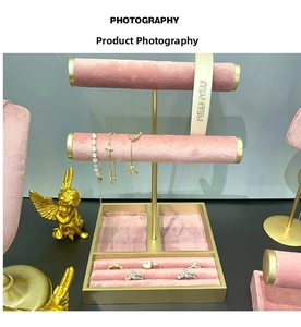 Pink velvet and gold metal jewelry display stand with dual tiers and ring storage slots