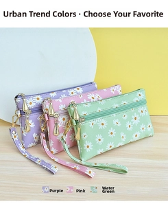 Three minimalist daisy print small wristlet bags in purple, pink and green colors