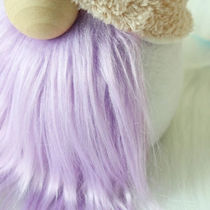 Detailed close-up of a plush gnome with purple faux fur beard and beige wool hat