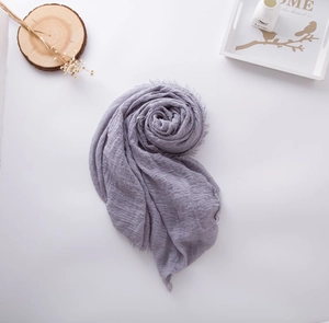 Detail shot of dusty purple cotton linen scarf with natural crinkle texture and frayed edges