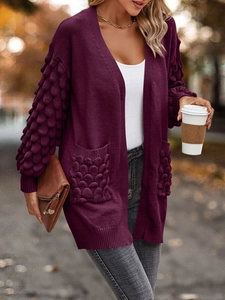 Women's deep purple knit cardigan with textured bubble sleeves and functional pockets