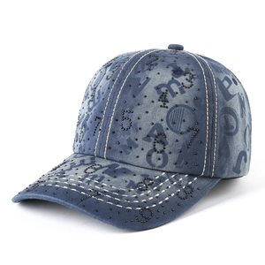Vintage washed denim baseball cap featuring numeric rhinestone patterns and contrast stitching