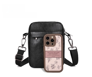 Detailed view of the black lychee pattern crossbody bag showing size next to a mobile phone