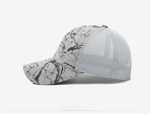 Detail of grey mesh back and marble print on the side of a breathable sport baseball cap