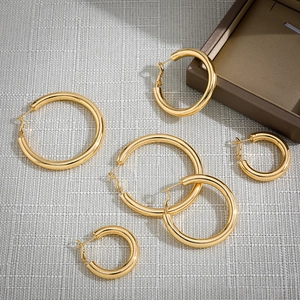 Detailed set of three polished 18K gold stainless steel hoop earrings in various sizes