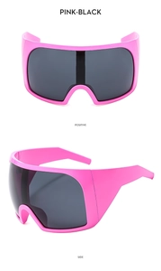 Detail view of pink wrap-around oversized sports sunglasses with black lenses in side profile
