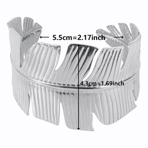 Close-up of wide silver cuff bracelet with leaf texture and 4.3cm width dimension