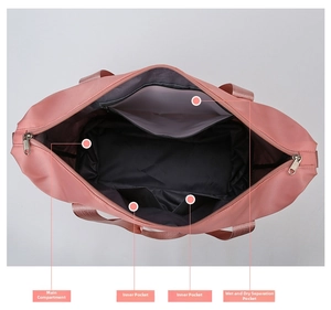 Detail view of pink travel bag interior showing main pocket and wet-dry separation pocket