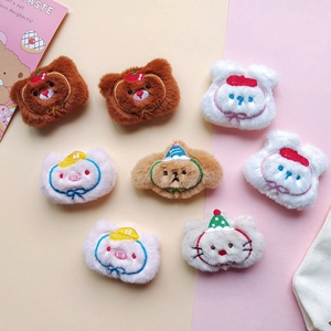 Detailed view of assorted plush animal patches with colorful embroidery and soft textures