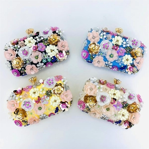 Detailed grid of handmade floral evening bags in black, blue, yellow, and beige satin