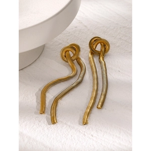 Macro detail of 16k gold plated snake chain tassel earrings with woven knot texture