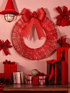 Close-up of red tinsel Christmas wreath with glowing LED lights and sequin bow detail