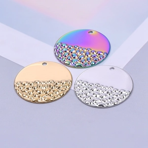 Three textured round stainless steel pendants in gold, silver, and rainbow finishes