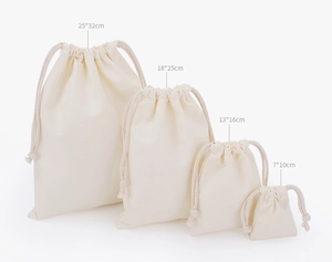 White cotton drawstring pouches in four different sizes for eco-friendly storage and packaging