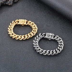 Close-up of punk rock skull charms on heavy Cuban link chains in gold and silver finish