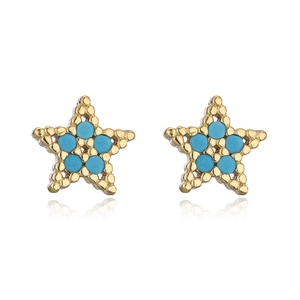 Detailed macro view of 18K gold plated star earrings with blue zircon inlays on white base