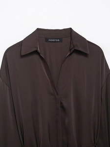 Detail of dark brown satin shirt featuring a classic lapel collar and silky texture