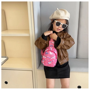 Girl wearing pink unicorn cross-body bag with adjustable strap and cute cartoon pattern