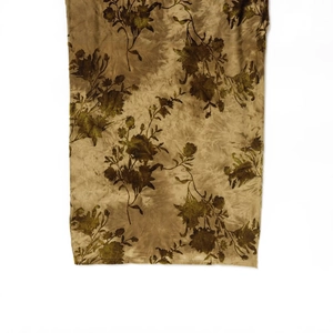 Brown and gold floral flocking velvet dress with pleated details on white background