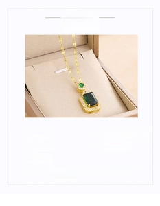 Detail view of square emerald green crystal pendant on gold titanium steel necklace