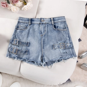 Flat lay of high waisted light blue denim shorts with distressed fringe and metal ring buckle