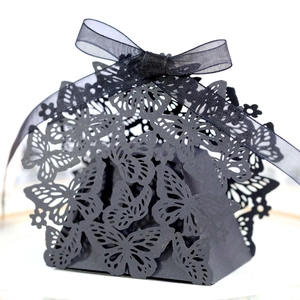 Detailed view of black laser-cut butterfly candy box with elegant ribbon bow