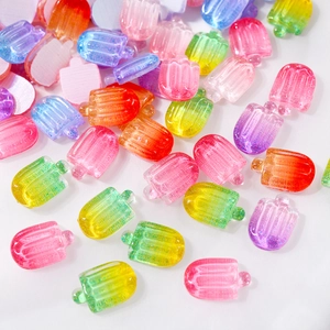 Macro shot of colorful resin ice cream nail charms with gradient glitter effects