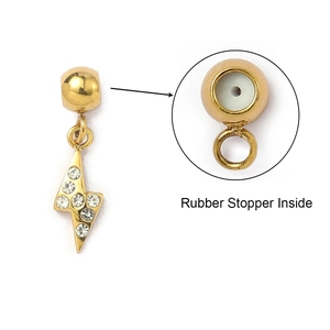 Detailed macro view of gold lightning charm with rhinestones and rubber stopper inside