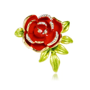 Close-up of red enamel rose brooch with gold edges and sparkling crystals