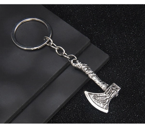 Detailed view of Viking double axe keychain with intricate metallic relief and textured handle