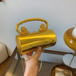 Golden acrylic cylinder evening bag with lion head handles and gold chain strap