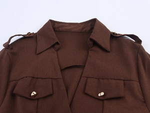 Detailed view of the dark brown cargo dress collar with shoulder epaulettes and gold buttons