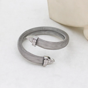 Macro detail of silver mesh bracelet featuring triangle ends and pavé rhinestone accents