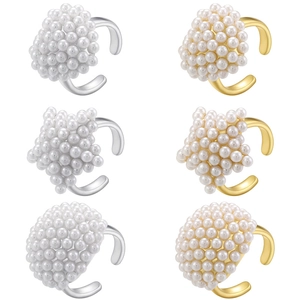 Macro view showing six sets of pearl ear clips in star and sphere shapes on metal bases