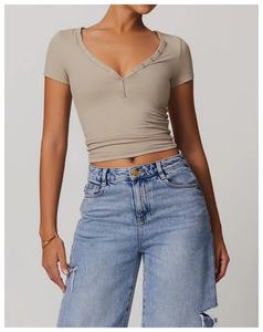 Detail of V-neck khaki slim fit sports T-shirt with decorative silver metal buttons