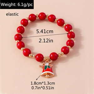 Detail of Christmas beaded bracelet with red bell charm and holly leaf pendant